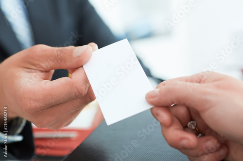 Business people change business cards on meeting seminar or conference.