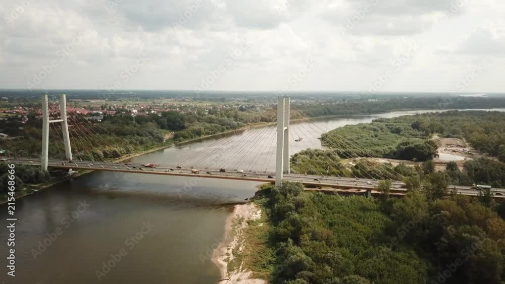 aerial drone shot : flying towards and over vehicles crossing road bridge over a river aerial drone shot : flying towards and over vehicles crossing road bridge over a river