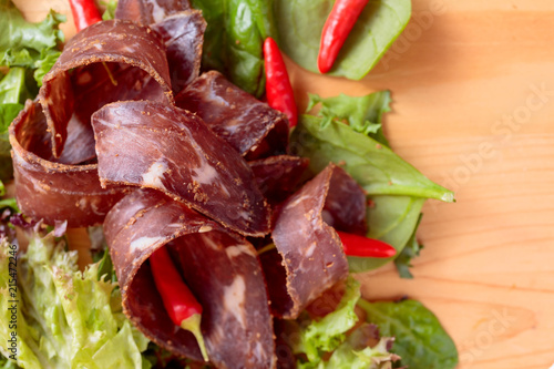 Dry beef jerky with herbs and red peppers.