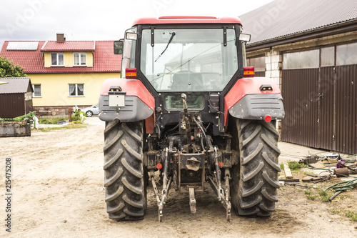 Tractor with hydraulic lift for carrying bales of hay and silage.Photo of a back view of an agricultural machine.The equipment for a dairy farm.