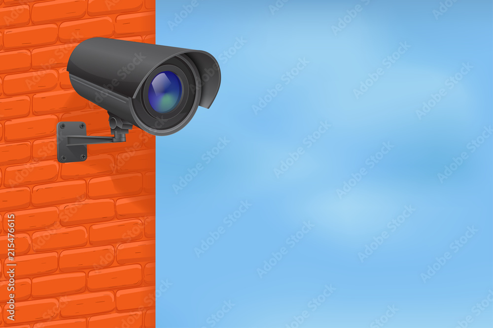Black security camera on red brick wall. With blue sky Black security camera on red brick wall. With blue sky