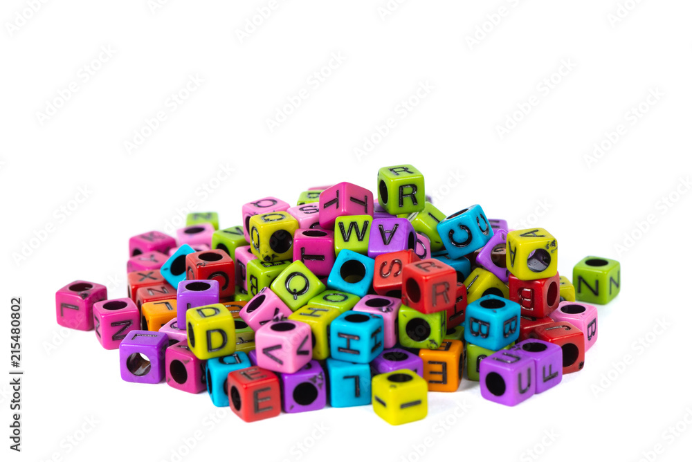 Pile of letter bead or beads with alphabet on white background.
