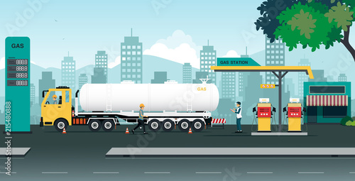 The truck is transferring oil at a station that is inspected by employees.