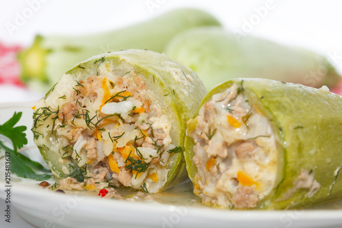 Stuffed zucchini with rice, minced meat and vegetables on white plate. Closeup image, homemade healthy cuisine.