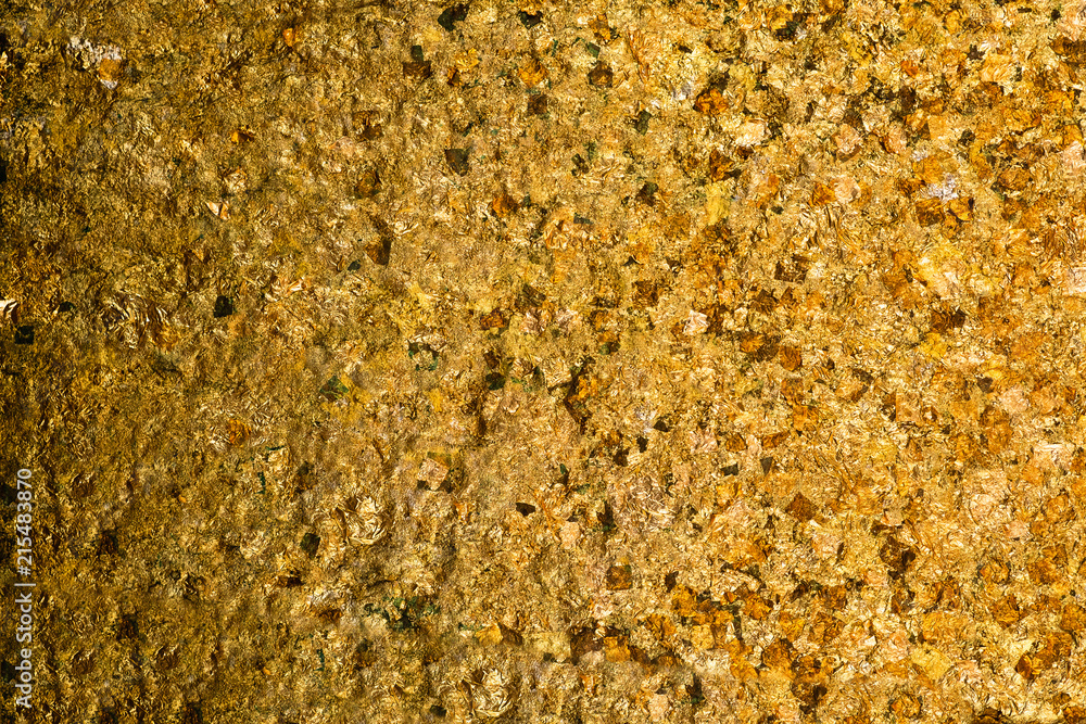 Shiny yellow gold leaf or scraps of gold foil background texture, surface from Back of Buddha image. Shiny yellow gold leaf or scraps of gold foil background texture, surface from Back of Buddha image.