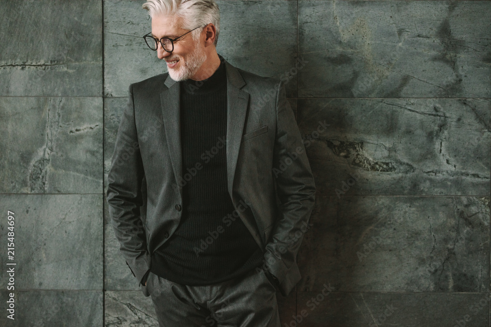 Handsome mature businessman against a wall Handsome mature businessman against a wall