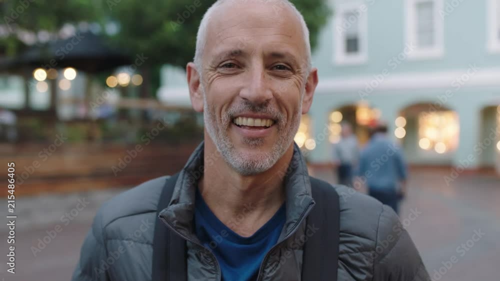 close up portrait of mature attractive caucasian tourist man looking at camera smiling urban background close up portrait of mature attractive caucasian tourist man looking at camera smiling urban background