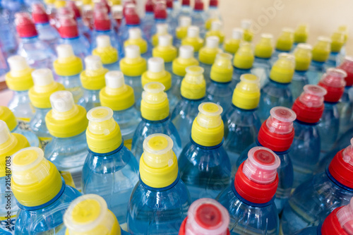 Lid plastic water bottle in the market. multi-colored plastic bottle caps 