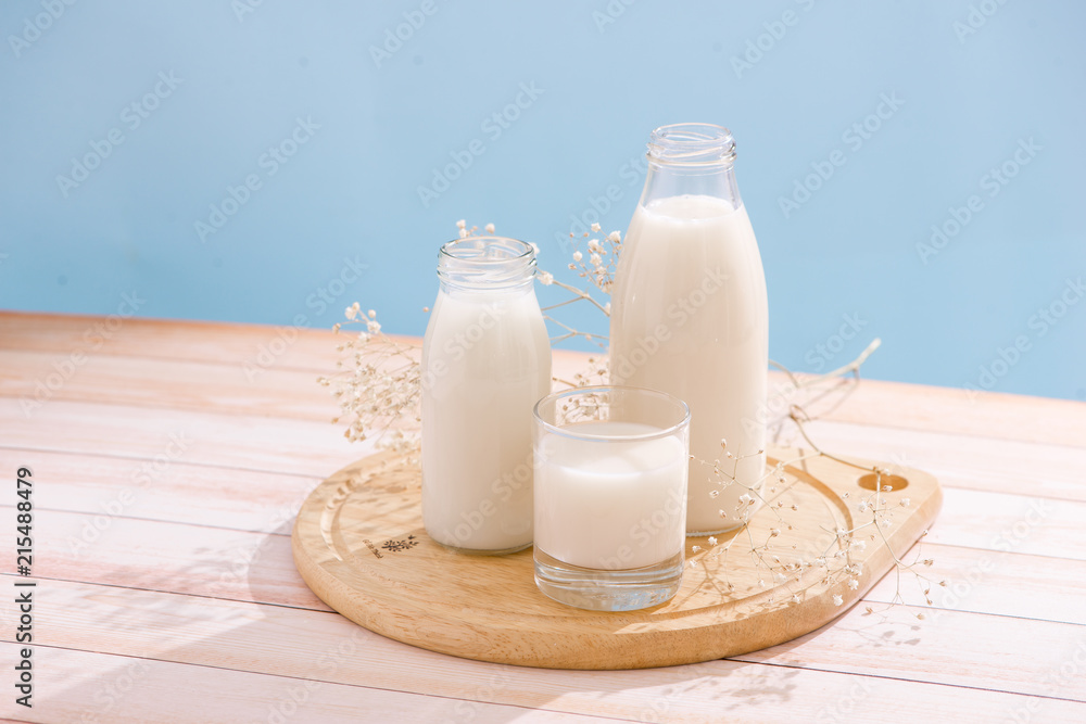 Dairy products. Bottle with milk and glass of milk on wooden table Dairy products. Bottle with milk and glass of milk on wooden table
