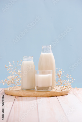 Dairy products. Bottle with milk and glass of milk on wooden table