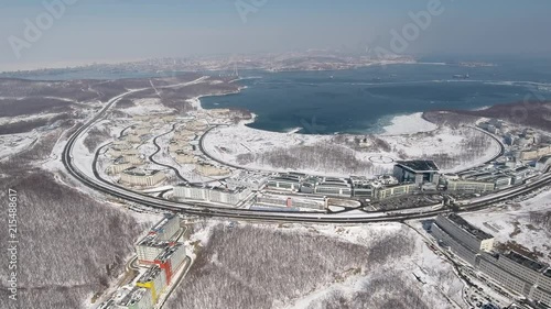 Aerial Bird's yey view general plan Far Eastern Federal University FEFU Summit Vladivostok Asia. modern building education Bay Isle quay Russian blue water sea cityscape. Winter cold snow frozen Sunny