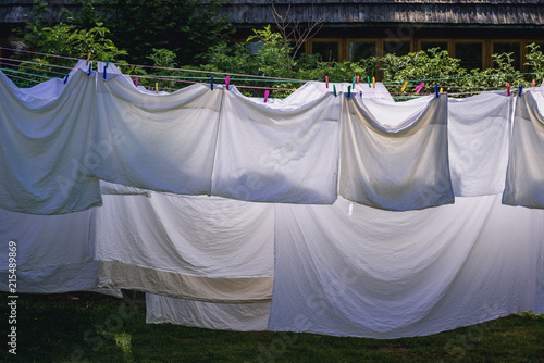 Sheets and pillow cases dries on a ropes photo