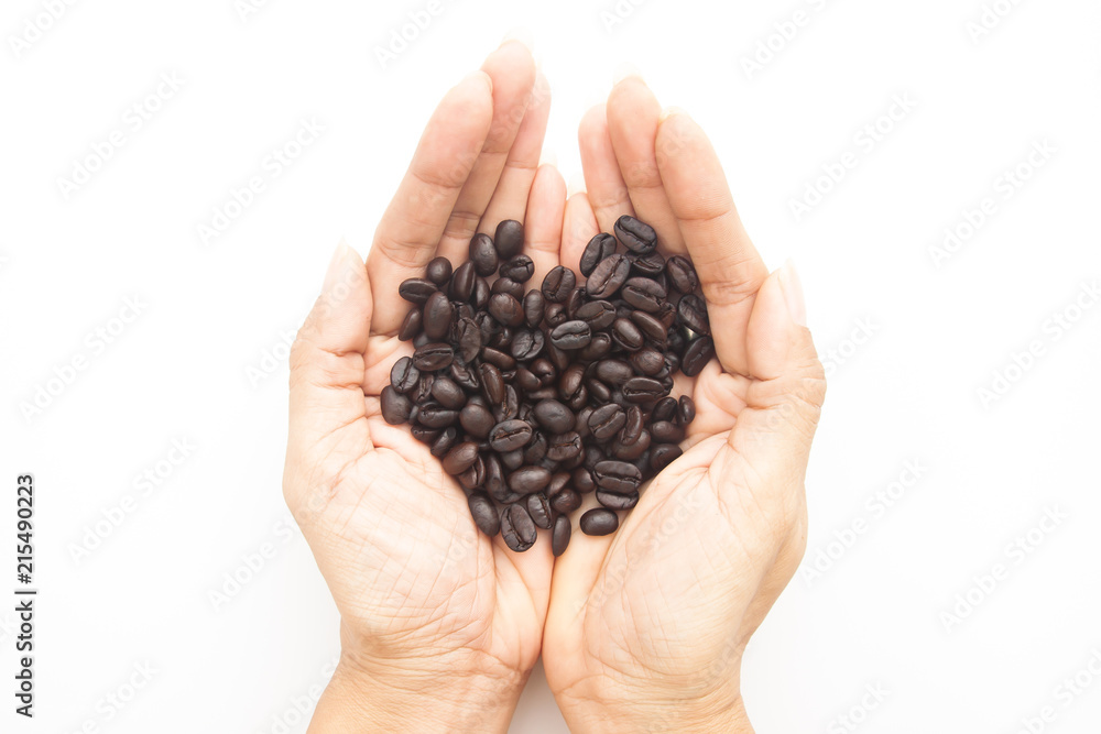 Roasted coffee beans on woman hands isolated on white background Roasted coffee beans on woman hands isolated on white background