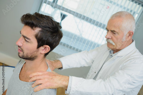Chiropractor working on young man's back