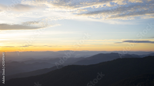 Panoramic scenery of the mist shrouded mountains at sunset