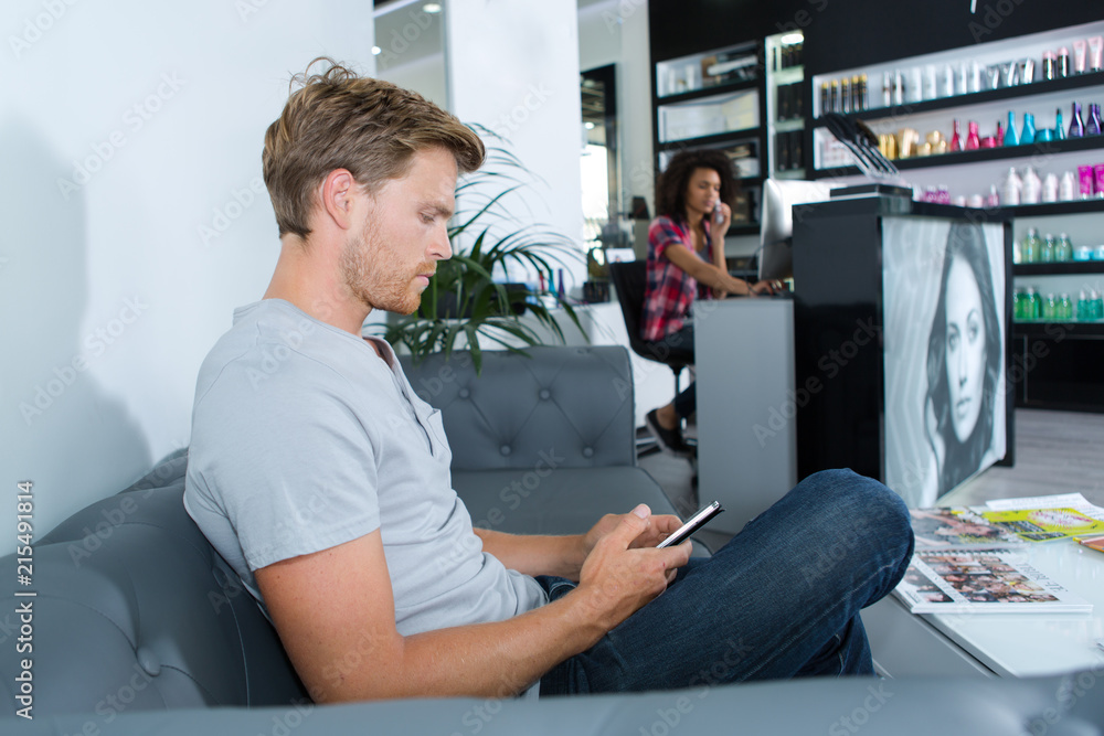 man waiting on a couch at the hairdressing salon man waiting on a couch at the hairdressing salon