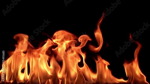 Fire flame isolated on black background. Slow motion / red, yellow, orange tongues of hot flame stream, twist and flash in a bewitching & hot dance on a black background