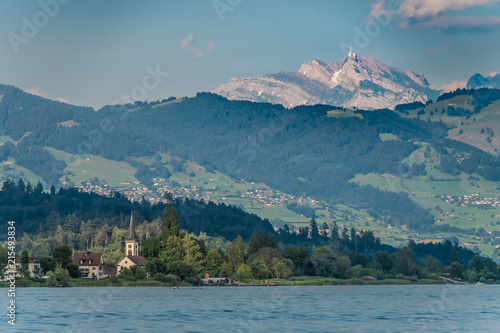 View of the Upper Zrucih Lake (Obersee), with the Santis peak and the village of Busskirch in the background, Sankt Gallen, Switzerland © Luis