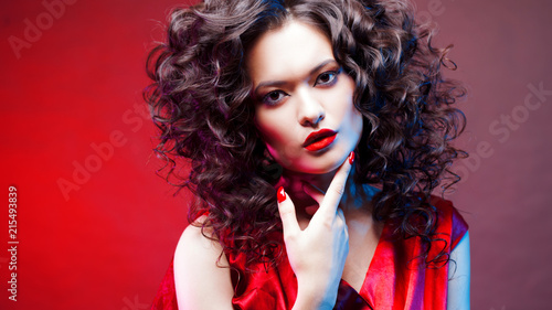 Voluminous hair. portrait of a beautiful young woman with red lipstick