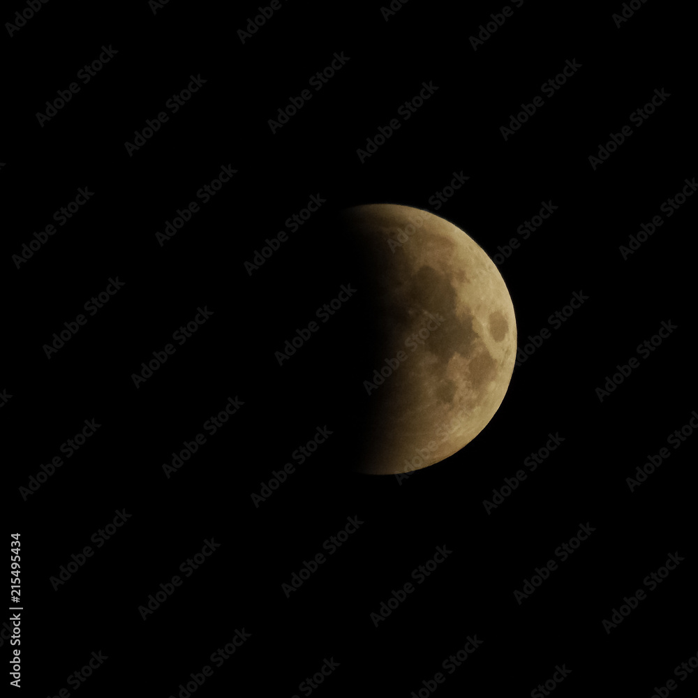 Omsk, Russia - July 28, 2018: The moment of a total lunar eclipse Omsk, Russia - July 28, 2018: The moment of a total lunar eclipse