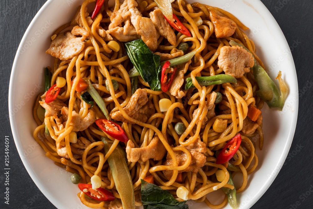 wok stir-fry egg noodles with fried chicken and thai spices and,  traditional spicy asian cuisine food Stock Photo | Adobe Stock