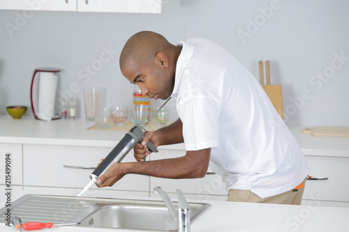 plumber in kitchen photo