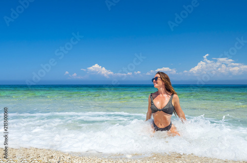 woman sunbathing on the beach photo