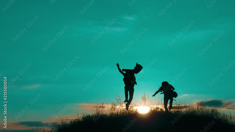 two men tourists hikers silhouette go to the mountains sunset travel slow motion video. lifestyle Traveler successful young men walking on top of Mountain and waiting for sunrise. travel tourists in two men tourists hikers silhouette go to the mountains sunset travel slow motion video. lifestyle Traveler successful young men walking on top of Mountain and waiting for sunrise. travel tourists in