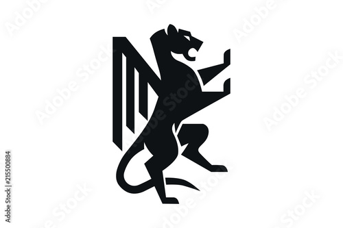 A lion rampant standing from a coat of arms or heraldic crest