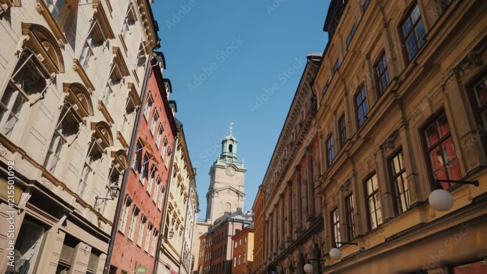 St Nicholas - Storkyrkan bell tower in Stockholm. View through a narrow street with old houses St Nicholas - Storkyrkan bell tower in Stockholm. View through a narrow street with old houses