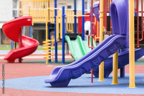 Children's colored slides playground on a street.