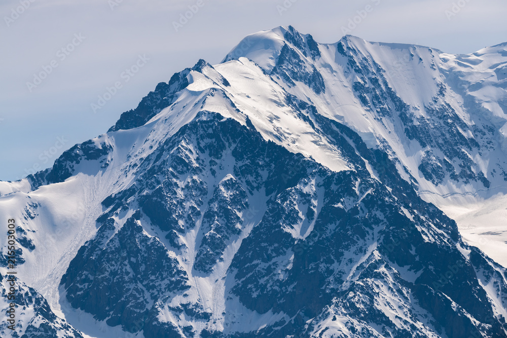 Obraz premium Mountain peaks covered with white shiny snow.