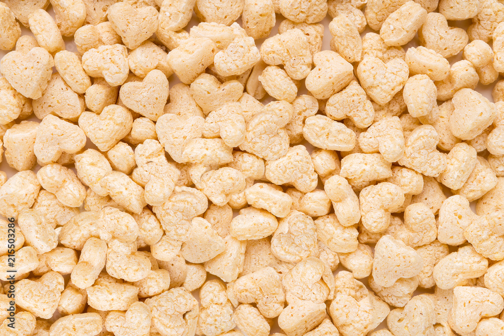 Tasty white cereals in heart form background