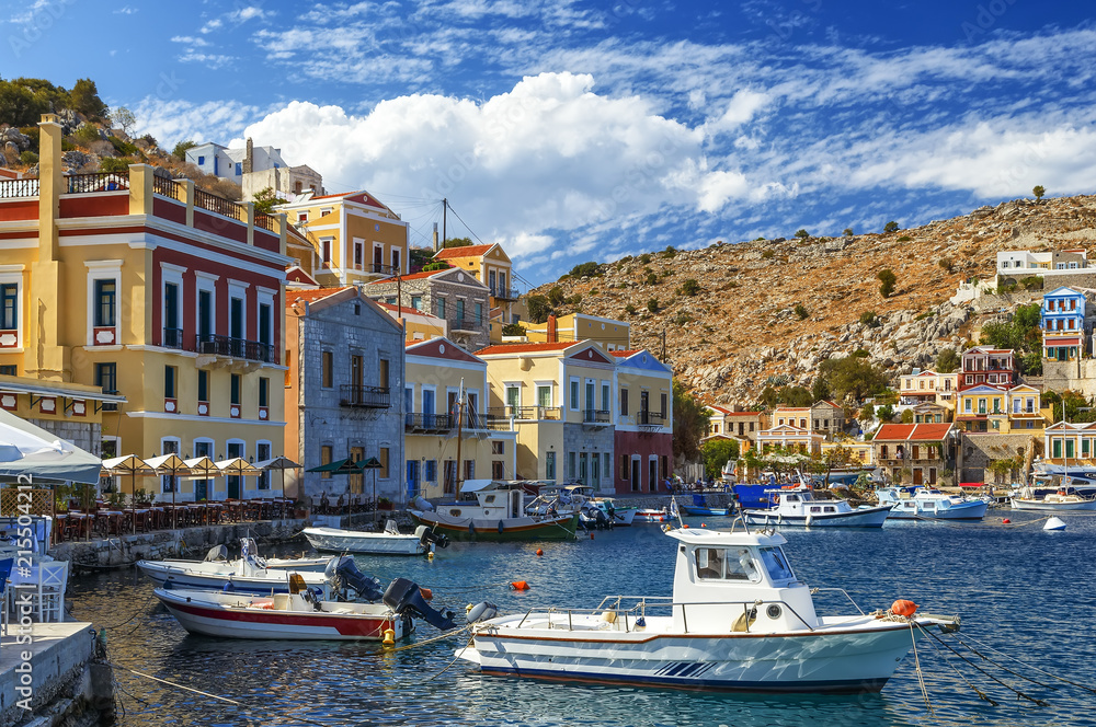 Scenic waterfront on the Greek island of Symi with bright and colorful fishing boats