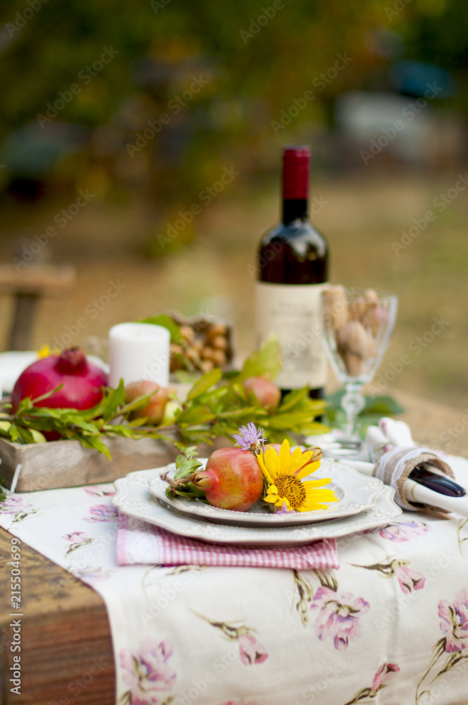 Lunch in the garden with wine and fruit. Romantic dinner in the open air. Autumn leaves of flowers. Beautiful table scrapbooking Lunch in the garden with wine and fruit. Romantic dinner in the open air. Autumn leaves of flowers. Beautiful table scrapbooking
