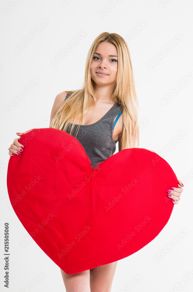 sexy girl holding a heart. isolated. sexy girl holding a heart. isolated.