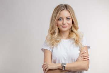 awesome charming blond model with pleasant smile. copy space. closeup photo. youth concept. isolated white background. studio shot. natural blonde