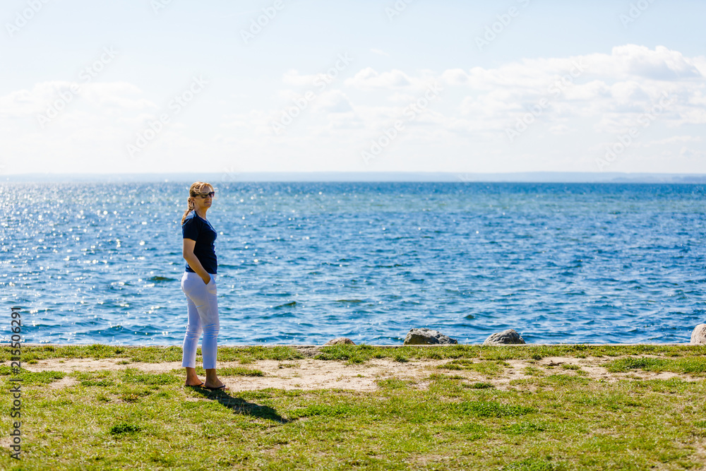 Woman standing at seaside