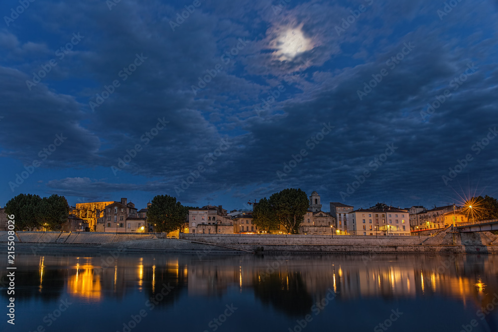 .Night panoramic view of the French city of Arles on the River Rhône. Provence. France.