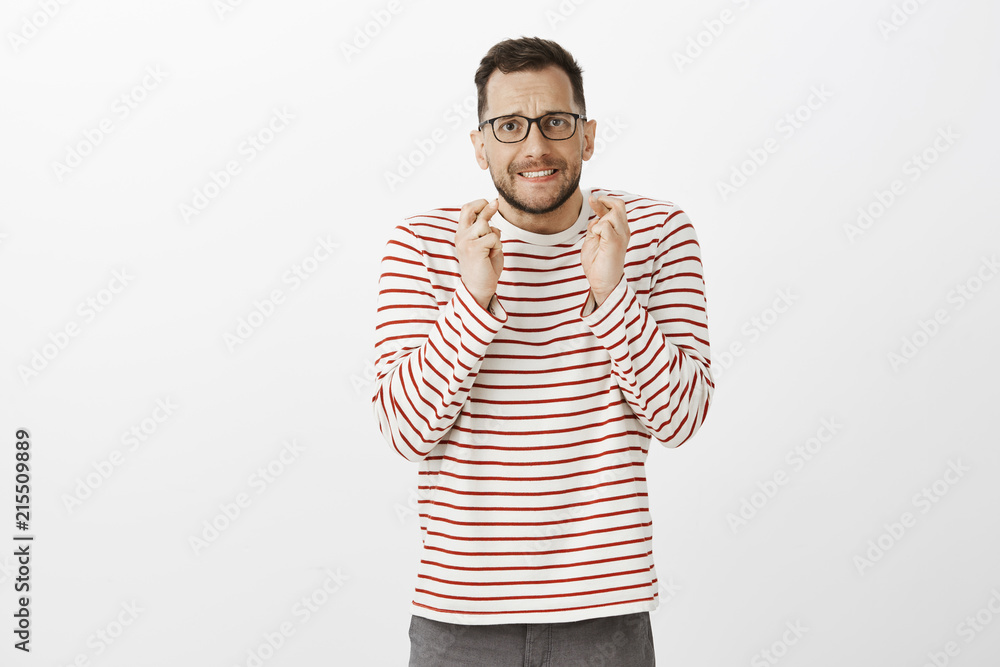 Please boss I need this chance. Worried and anxious handsome male with bristle in trendy black glasses, raising crossed fingers and biting lip while intensely praying or wishing for dream come true Please boss I need this chance. Worried and anxious handsome male with bristle in trendy black glasses, raising crossed fingers and biting lip while intensely praying or wishing for dream come true
