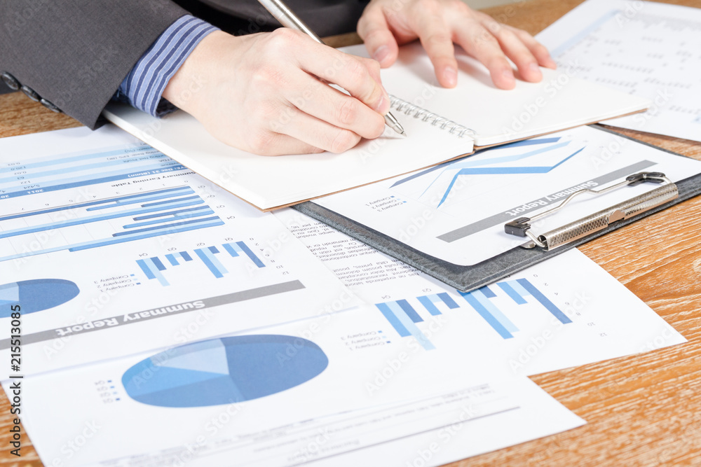 business man analyzing graph and chart document report business man analyzing graph and chart document report