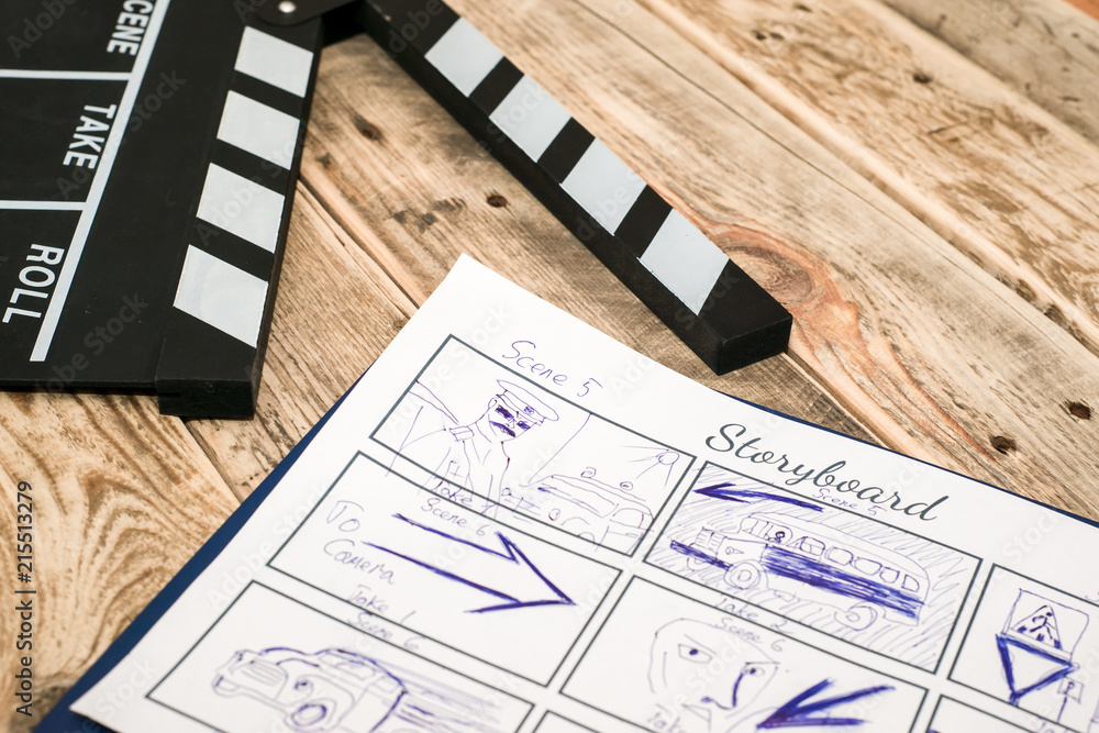 Naklejka premium clapperboard, storyboard on wood