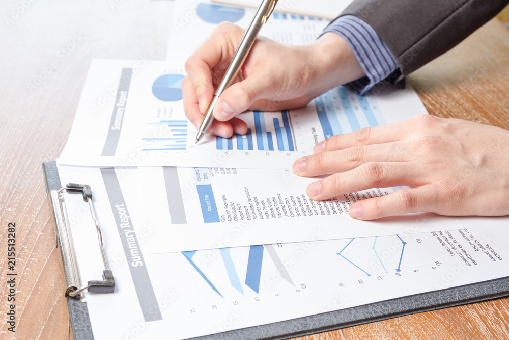 business man analyzing graph and chart document report business man analyzing graph and chart document report