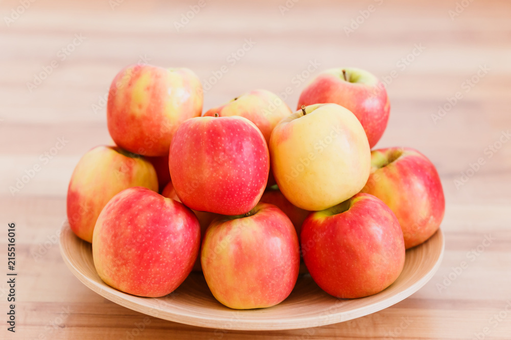 red ripe apples on a wooden plate red ripe apples on a wooden plate