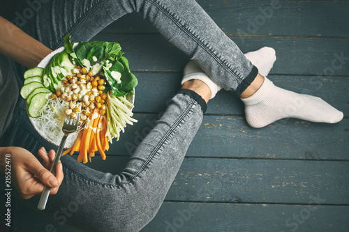 woman having Healthy breakfast, raw vegan food in Buddha Bowl photo