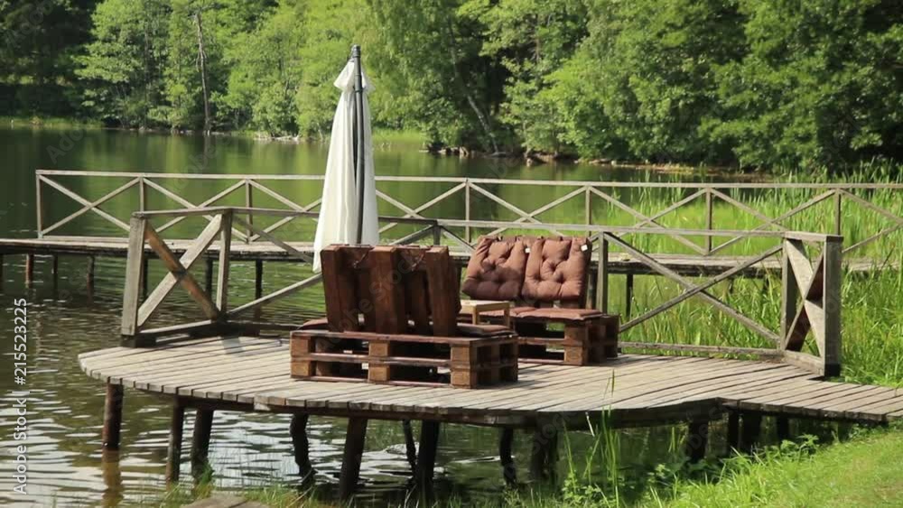 Wooden bridge to the lake on a sunny summer day Wooden bridge to the lake on a sunny summer day