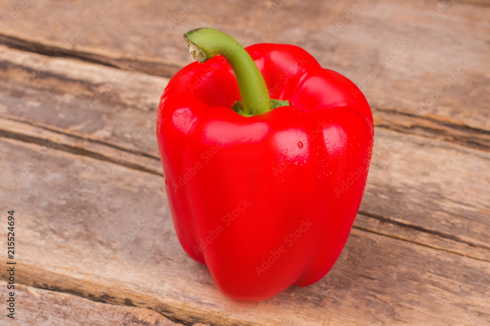 Fresh, sweet, red bell pepper. Old rustic wooden table background. Fresh, sweet, red bell pepper. Old rustic wooden table background.