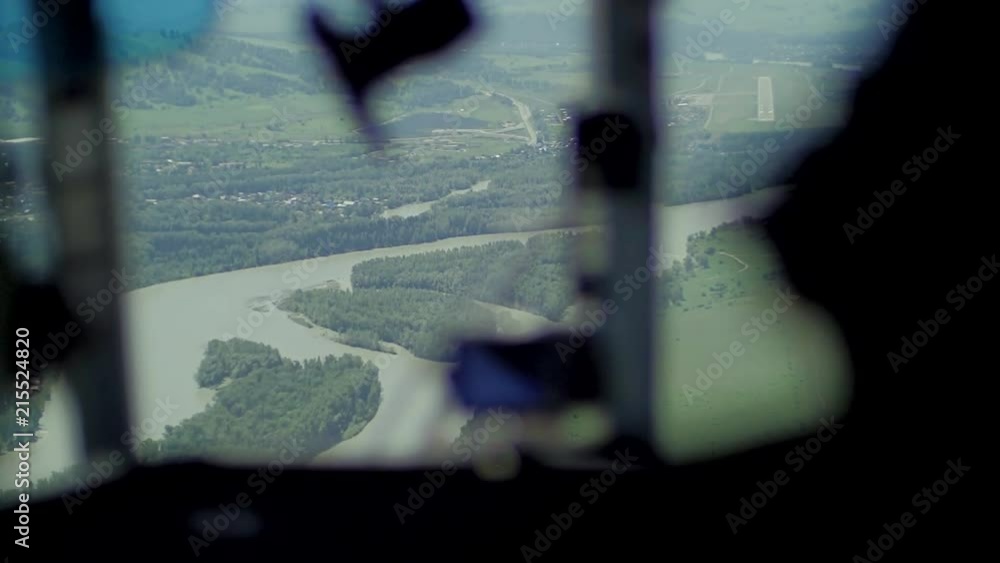 View from inside of helicopter cockpit of meadows and fields. View from inside of helicopter cockpit of meadows and fields.