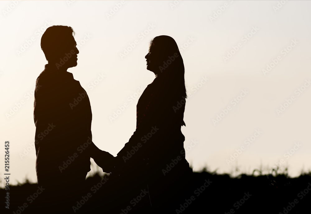 Silhouette a happy couple holding each other