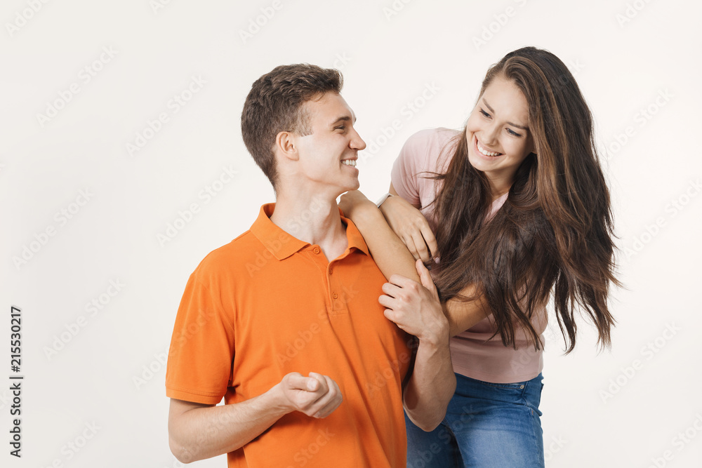 Happy lovely couple smiling and talking to each other about something. Studio shot over white background Happy lovely couple smiling and talking to each other about something. Studio shot over white background